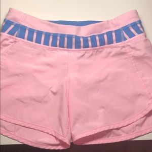 pink ivivva shorts with blue stripped waistband